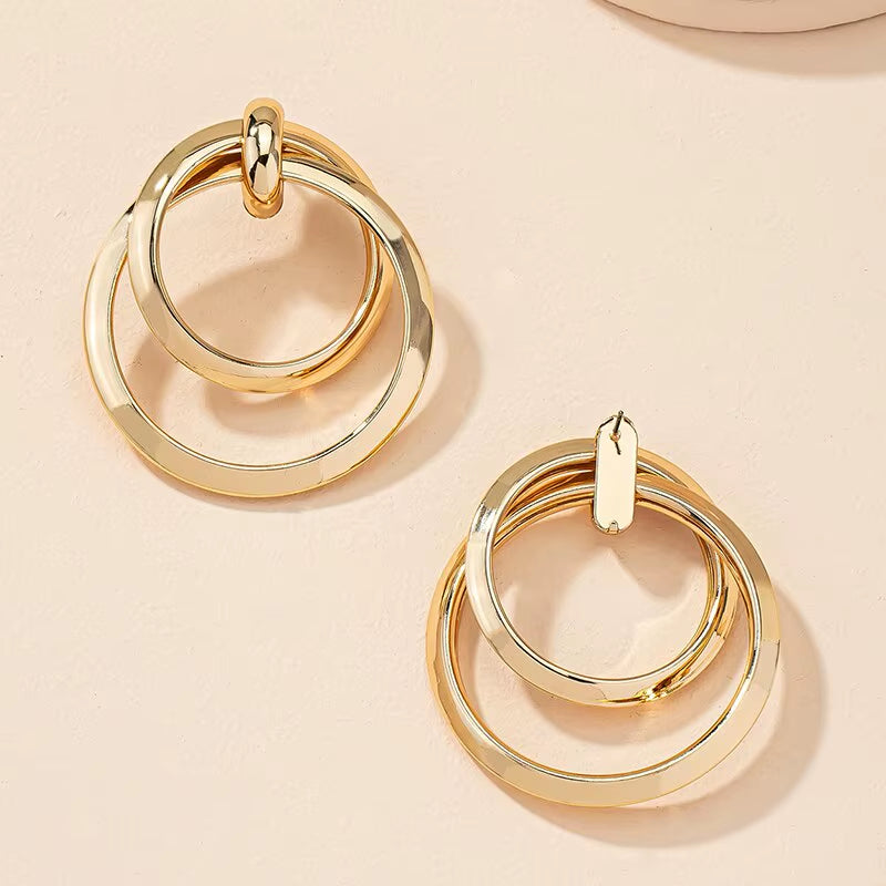 Bold Nights and Twisted Glam– Gold Statement Hoop Earrings